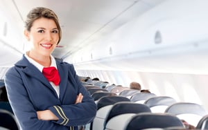 Beautiful air hostess in an airplane smiling